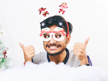 Man in novelty glasses giving two thumbs up