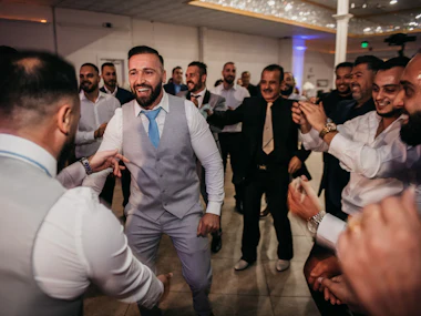 Guests in suits dancing at a celebration