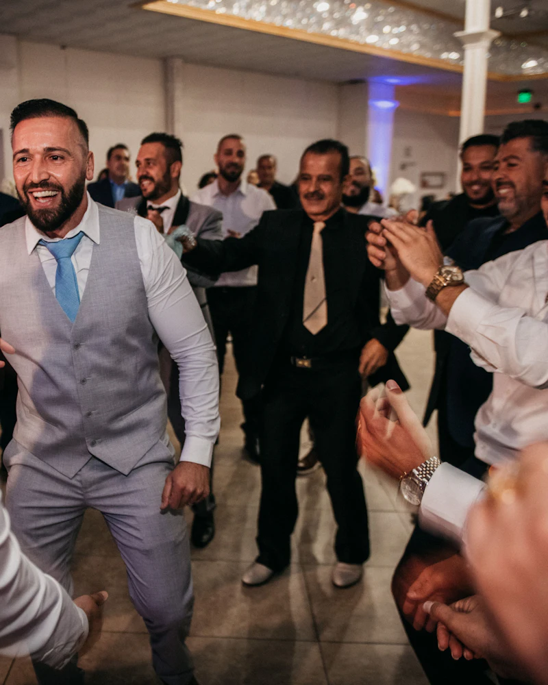 Guests in suits dancing at a celebration