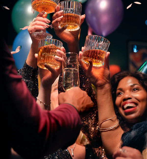 Friends raising a toast and laughing at a party
